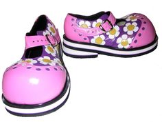 two pairs of pink shoes with white and yellow flowers painted on them, one is for girls