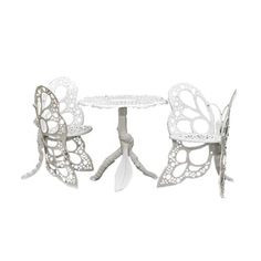 two white butterflies sitting on top of a table