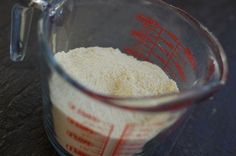 a measuring cup filled with flour on top of a table