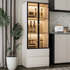 a white and black kitchen with an open cabinet in the corner, next to a potted plant