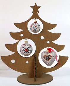 a cardboard christmas tree with ornaments hanging from it