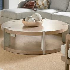 a living room with couches and a table in the middle, on carpeted flooring