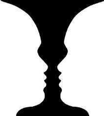 the silhouette of two people's heads are shown in black against a white background