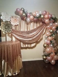 the balloon arch is decorated with pink, silver and gold balloons for a wedding reception