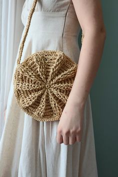 a woman wearing a white dress holding a brown purse