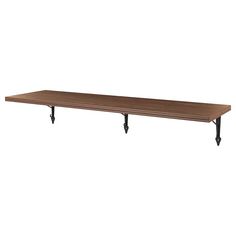 a wooden shelf sitting on top of a white wall next to two black metal legs