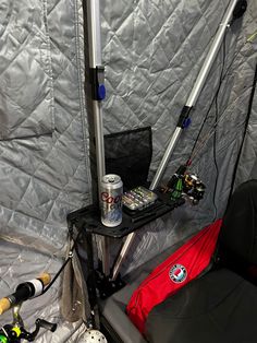 the inside of a tent with fishing gear and equipment on it's side,