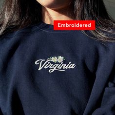 "*SIZES ARE UNISEX* -I'd suggest your usual size for a regular fit, or sizing up for a more relaxed fit. *these sweatshirts are extra comfy when oversized 🌼 \"Virginia\" and a flower design embroidered on a comfy cute crewneck. A sturdy and warm sweatshirt bound to keep you warm in the colder months. A pre-shrunk, classic fit sweater that's made with air-jet spun yarn for a soft feel and reduced pilling. Your new favorite sweatshirt! * 50% cotton, 50% polyester * Pre-shrunk * Classic fit with n Spring Crew Top With Embroidered Logo, Oversized Sweatshirt With Embroidered Text, Spring College Sweatshirt With Letter Embroidery, Spring College Sweatshirt With Embroidered Logo, College Spring Sweatshirt With Letter Embroidery, Spring Crew Sweatshirt With Embroidered Text, Spring Sweatshirt With Custom Embroidery And Relaxed Fit, Spring Sweatshirt With Custom Embroidery In Relaxed Fit, Streetwear Floral Embroidered Crew Neck Top