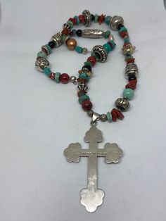 "This piece is so beautiful. It is a genuine, vintage, Taxco multi stone and sterling silver cross necklace. The necklace is 22 inches. The necklace features gorgeous, natural blue turquoise, red coral, carnelian, black onyx and sterling silver beads with a huge stamped sterling silver and black onyx cross. The stones are nuggets, round beads, rondelle beads. The sterling silver beads are stunning with etchings, including flowers, scrollwork, ribbed and other designs; some beads are shaped like Handmade Bohemian Cross Pendant Necklace, Bohemian Cross Pendant Necklaces For Jewelry Making, Bohemian Crucifix Necklace As Gift, Bohemian Crucifix Necklace As A Gift, Bohemian Crucifix Necklace, Handmade Turquoise Cross Necklace Spiritual, Handmade Spiritual Turquoise Cross Necklace, Bohemian Turquoise Cross Necklace, Silver Bohemian Cross Necklace