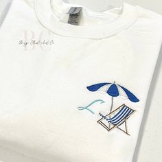 Elevate your coastal style with our minimalist summer sweatshirt, featuring an embroidered beach chair and umbrella design. Personalize it with your custom colors and initial for a unique touch. Ideal for beach lovers looking for aesthetic comfort and style.  ❥ Sweatshirt Details: * Crewnecks and hoodies are ADULT, UNISEX Gildan sweatshirts * 50% cotton/50% polyester * They may shrink a little after washed! We recommend to size-up if you want a more comfortable/oversized look * Please review the Hamptons Summer, Summer Sweatshirt, Minimalist Summer, Beach Chair Umbrella, Umbrella Designs, Beach Chair, Style Aesthetic, Gildan Sweatshirts, Custom Initials