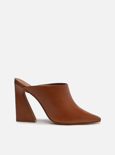 Brown leather mule. The style features a block heel with a flared base and a pointed toe. It has a closed upper that covers the entire top of the foot. Open at the back, it shows the heel. With an insole matching the color of the mule. Why follow this trend? Whether you are dressing up for a night or adding some glamou Brown Kitten, Block Heel Mule, Block Heel Mules, High Heel Mules, Leather Mules, Brown Shoe, Chic Dress, Leather Slip Ons, Favorite Jeans