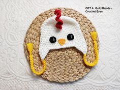 a crocheted chicken with a hat on it's head