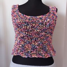 A blouse knitted from floss yarn that you can easily wear as jeans, shorts, a skirt or a bikini top on hot summer days, and it will never make you sweat and is light enough that you won't even feel it. It is suitable for size M-L and can be worn on both sides. It is sensitive because it is made of flush thread. It should be washed by hand or in a machine at very low temperature on a delicate setting, not with your other clothes. We will be happy to get back to you with any questions you may have Knitted Fitted Sleeveless Crop Top, Fitted Knitted Sleeveless Crop Top, Fitted Sleeveless Knitted Crop Top, Trendy Crochet Lace Top For Summer, Multicolor Knit Top For Summer, Multicolor Sleeveless Knit Top For Summer, Multicolor Knit Tank Top For Summer, Summer Cropped Stretch Knit Top, Trendy Crochet Crop Top For Festivals