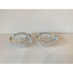 two clear glass dishes with gold rims