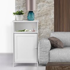 a living room with a chair, table and vase on the shelf next to it