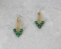 This one of a kind pair of earrings is made from hand crafted gold German Style wire, green and black glass beads, and nickel free ear wires. Earrings, from ear wire to bottom bead are 2  3/4" in length. I invite you to come on in and browse my shop's entire selection of handcrafted jewelry! https://www.etsy.com/shop/BeauFaireCreations Cheap Green Beaded Earrings, Stitch Beads, Hand Beaded Earrings, German Style, Jewelry Making Earrings, Diy Earring, Earrings Diy, Earring Ideas, Making Earrings