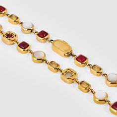 Set Contains: - Red Crystal Gemstone Necklace (Gold)- Red Crystal Gemstone Bracelet (Gold)- 2x CRAFTD Luxury Gift Box The Crystal Gemstone Necklace & Bracelet feature a striking contrast of real pearl alongside red and yellow crystal. Set within secure bezel settings, each premium-cut gem boasts beveled edges that not only enrich its natural color but also ensure enduring durability. Yet, it's the larger, oval-cut mother-of-pearl and 18K Gold clovers that truly command attention. Designed for a Luxury Red Gemstone Bracelets, Luxury Red Jewelry With Gemstone Accents, Elegant Natural Ruby Gemstones, Gold Gemstones Jewels Gift, Gold Gemstones For Gifts, Elegant Red Multi-stone Jewelry, Formal Red Gemstones With Accents, Elegant Red Natural Gemstones, Red Gemstone-accented Jewelry For Formal Occasions