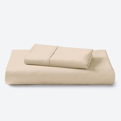 the sheets and pillowcases are folded on top of each other, with one sheet pulled down