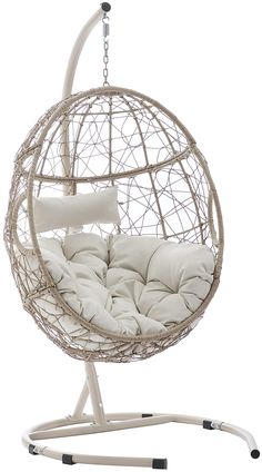 a white hanging chair with pillows on it