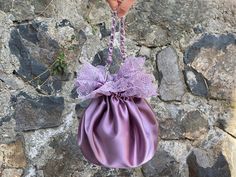 🔘 This Elegant Satin Ruffle bag is ideal for the wedding day, night out, party, special occasion, brides, bridesmaids, mothers of the bride, or any formal fun. 🔘 This bag has an elastic opening and a stiff bottom.   🔘 Please contact for a custom order. 🔘 Material: Satin fabric, lace. The lining fabric is the same fabric as on the outside.  🔘 Measurements: - The bottom diameter is 12 cm/4.7 inches. - Height comes in 3 different measurements and the height was measured until the ruffles and e Feminine Party Bags With Pearl Handle, Feminine Handheld Evening Shoulder Bag, Elegant Purple Handheld Bag, Feminine Evening Shoulder Bag With Pearl Handle, Elegant Purple Shoulder Bag, Elegant Purple Party Bag, Satin Pouch Evening Bag For Parties, Purple Evening Bag For Wedding, Elegant Purple Shoulder Bag For Party