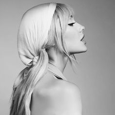 black and white photograph of a woman with long blonde hair wearing a bandana on her head