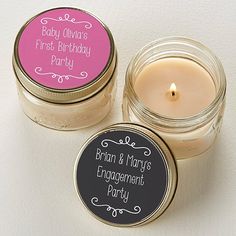 two small jars filled with candles sitting next to each other