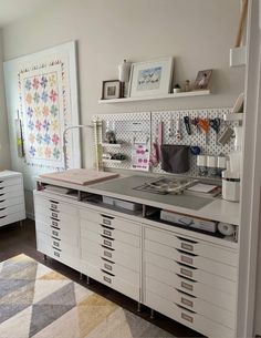 an organized craft room with lots of drawers