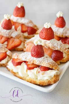 a slice of cake with strawberries and whipped cream on top