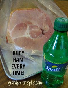 a plastic container filled with ham next to a bottle of sprite juice on a wooden table