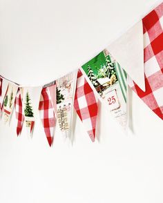 a red and white checkered bunting is hanging on the wall with christmas cards