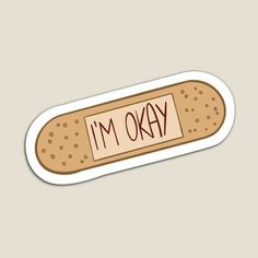 an i'm okay sticker with the word on it in red ink and brown dots