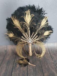 a black and gold feathered hat on a wooden table