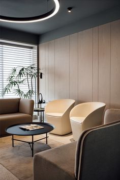 a living room filled with furniture next to a large window covered in blinds and wooden slats