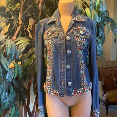 You Will Get Complements In This Stunning Turquoise Beaded Jean Jacket! Jacket Covered With Beads On Collar, Down Front, On Cuffs, On Waist And Design On Back!! No Stones Missing Or Loose!! The Cross On The Back Makes This Jacket Versatile Across Generations And Ability To Wear With Anything! Signature Gordon And James Designed #Turquoise #Country #Concert Beaded Blue Denim Jacket For Spring, Spring Beaded Blue Denim Jacket, Spring Blue Beaded Denim Jacket, Fitted Long Sleeve Beaded Outerwear, Spring Blue Beaded Outerwear, Fitted Blue Embellished Outerwear, Blue Embellished Fitted Outerwear, Casual Long Sleeve Beaded Outerwear, Fitted Multicolor Denim Jacket With Long Sleeves