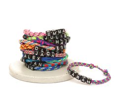 A cute letter beaded kids bracelet can be personalized with a your chosen name. Featuring black letter alphabet beads on an adjustable paracord. Available in 15 different colors. It is comfortable to wear and fastens with a super simple adjustable sliding knot. Adjustable Letter Print Friendship Bracelets As Gifts, Adjustable Letter Print Friendship Bracelets Gift, Adjustable Friendship Bracelets With Letter Print For Gift, Adjustable Beaded Bracelet With Letter Print For Birthday, Adjustable Letter Print Friendship Bracelet As Gift, Adjustable Friendship Bracelets With Letter Print, Adjustable Letter Print Bracelets For Personalized Gifts, Adjustable Bracelet With Letter Print For Personalized Gift, Adjustable Name Bracelet For Birthday