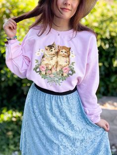 This is the Vintage Kitten Crewneck Sweatshirt. The soft, warm material is made from a blend of cotton and polyester. It has no itchy side seems and a trendy, loose fit. The cool design on this cottagecore crewneck features a collage of vintage kitty and flower illustrations salvaged from old books and ephemera. PLEASE SIZE UP 2-3 SIZES FOR A TRENDY, LOOSE FIT! This design is created by Jillian Anderson @ A Living Whimsy. She uses digital graphic design elements and collage and optimizes each im Cute Long Sleeve Sweatshirt With Cat Design, Cat Design Cotton Long Sleeve Sweatshirt, Relaxed Fit Long Sleeve Sweatshirt With Cat Print, Spring Long Sleeve Tops With Cat Design, Cute Long Sleeve Sweatshirt With Cat Print, Casual Crew Neck Sweatshirt With Cat Print, Cotton Crew Neck Sweater With Cat Design, Casual Relaxed Fit Sweatshirt With Cat Print, Casual Sweatshirt With Cat Print In Relaxed Fit