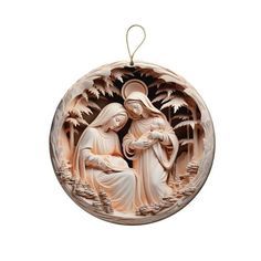 a christmas ornament with an image of the virgin mary and child jesus on it