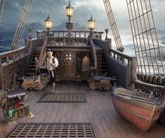 there is a man standing on the deck of a ship with many items around him