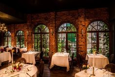 the dining room is set for dinner with white linens and tablecloths on tables