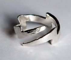 "The Lightning Bolt symbolizes many things to people in different world cultures: honesty, fertility, strength, intellect, illumination..union of fire and water, power, swiftness, just to name a few...To me, it symbolizes sudden divine inspiration, truth & energy. I love this symbol! Cast in solid Sterling Silver with a hammered finish, this wrap-around ring can be adjusted to fit US sizes 4-9. This is a variation of my original lightning bolt ring but has 2 tapered ends, instead of 1 wide a Bolt Rings, Lightning Ring, Lightning Bolt Ring, Lightning Scar, Water Power, Silver Shark, Fire And Water, Bolt Ring, Sterling Silver Cat