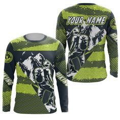 a green and black long sleeved shirt with an image of a man riding a motorcycle