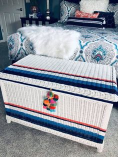 a bed with blue and white bedspread on top of it