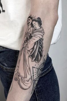 a woman with a tattoo on her arm holding onto another person's arm,