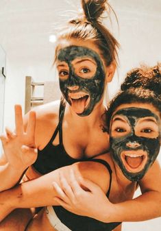 two women with their faces painted in black