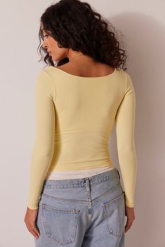 A soft and seamless essential, this go-to long sleeve features a square neckline and formfitting silhouette. **Fit:** Formfitting, fitted sleeves, slightly cropped **Features:** Soft fabrication, seamless design, square neckline **Why We | Clean Lines Long Sleeve by Intimately at Free People in Yellow, Size: XS/S Free People Shirts, Yellow Long Sleeve Outfit, Light Yellow Top, Yellow Long Sleeve Shirt, Conan Grey, Yellow Clothes, Yellow Tops, Free People Long Sleeve, Yellow Long Sleeve