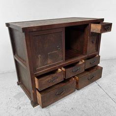 an old wooden cabinet with drawers is shown