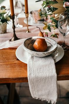 a plate with a pear on it sitting on a table