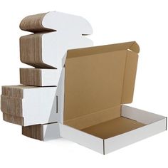 an open box sitting on top of cardboard boxes with the lid opened and stacked up