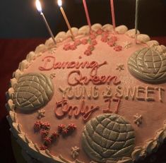 a birthday cake with lit candles on it