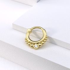 "Make a statement with our exclusive tribal solid gold septum ring with Genuine white diamonds, perfect for adding elegance, luxury and uniqueness to your look Materials: * 14K Solid Gold (Weight: 1.2g) - Available in yellow, rose or white gold. * Genuine White Diamonds (Weight: 0.03ct VS-SI/G-H) Measurements: Wire thickness: 18g - 1mm Inner diameter of the ring: 0.3\" - 8mm Wire thickness \" 16g - 1.2mm Number of diamonds: 1 Diamond size: 2mm * Nickel free and hypoallergenic Fits: septum, tragu Elegant Small Hoop Gold Septum Ring, Elegant Gold Septum Ring With Halo Detail, Elegant Gold Septum Ring With Halo, Elegant Gold Small Hoop Septum Ring, Gold Halo Septum Ring For Wedding, Gold Cartilage Earrings With Diamond Accents, Elegant Gold Halo Septum Ring, Gold Diamond Septum Ring As Gift, Elegant Gold Septum Ring With Diamond Accents